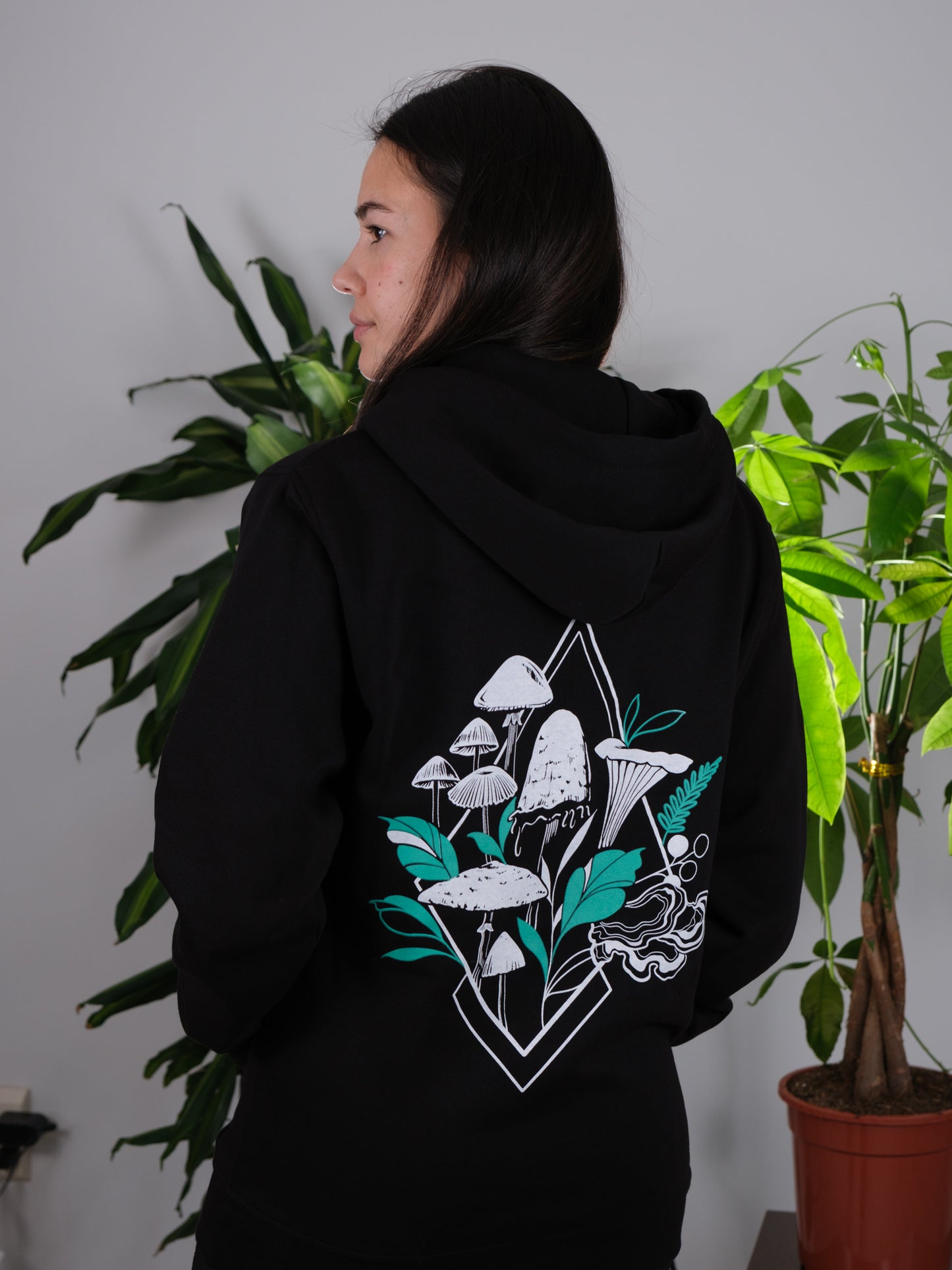 Female model displaying the back of the Fragrance of Fall Hoodie, highlighting the intricate mushroom design