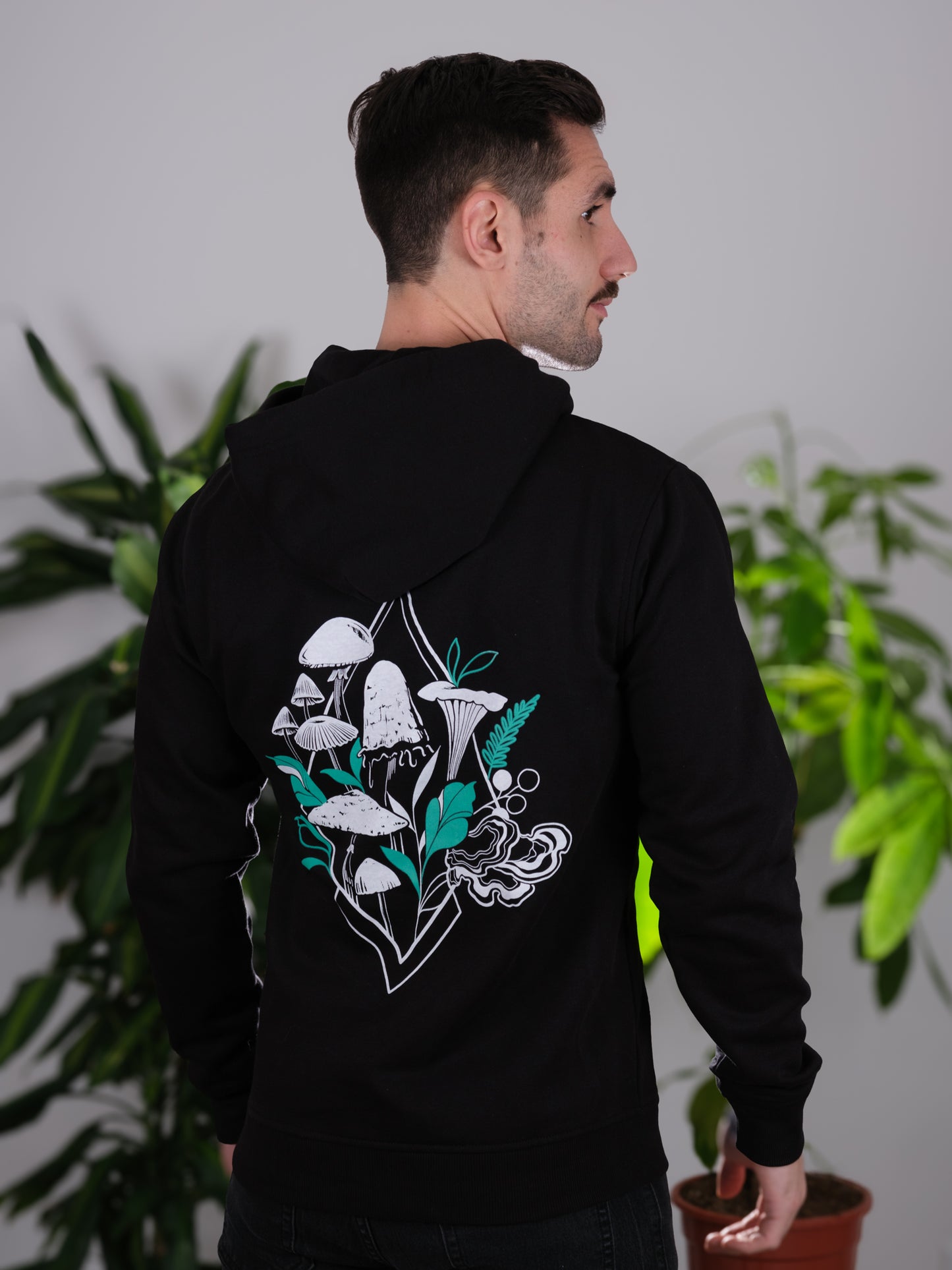 Back view of the Fragrance of Fall Hoodie on a male model, featuring tattoo-inspired geometric mushroom art.