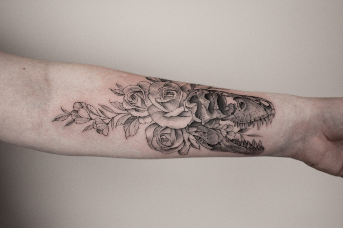 Floral dinosaur tattoo on a woman's arm
