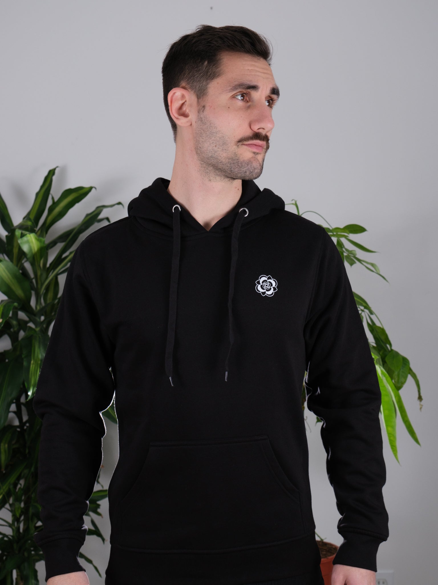 Male model front view wearing Love Knows No Bounds hoodie, highlighting minimalist and tattoo-inspired art.