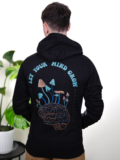 Male model back view wearing Let Your Mind Grow hoodie, featuring detailed mushroom, psychedelic, and nature-inspired tattoo design.