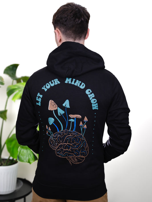 Male model back view wearing Let Your Mind Grow hoodie, featuring detailed mushroom, psychedelic, and nature-inspired tattoo design.