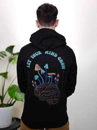 Let Your Mind Grow hoodie back design on a male model, featuring detailed mushroom and floral tattoo-inspired art.