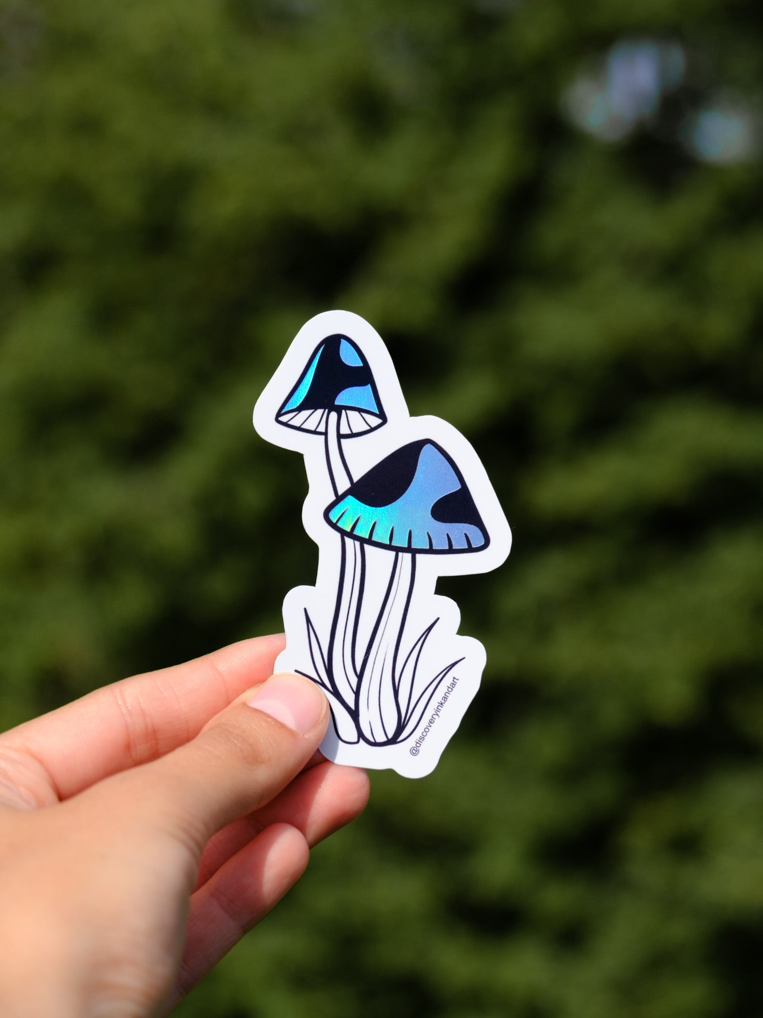 Two tattoo-inspired holographic mushrooms on a stickers