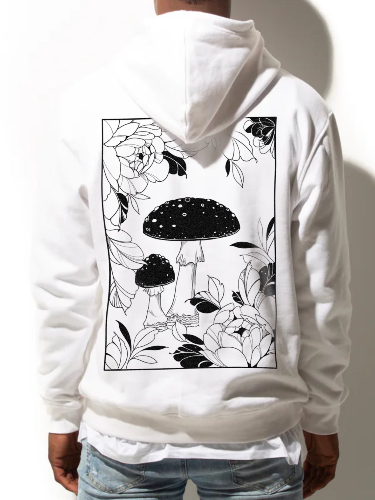 Amanita Muscaria Mushroom art surrounded by tattoo-inspired florals on a white hoodie