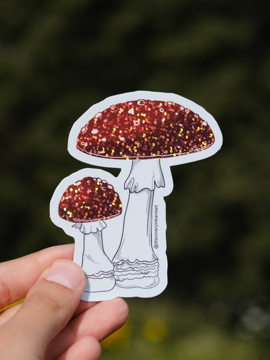 Glittery and glossy Amanita Muscaria Mushroom Sticker by Sea, perfect for adding a vibrant touch to personal items like laptops and skateboards.