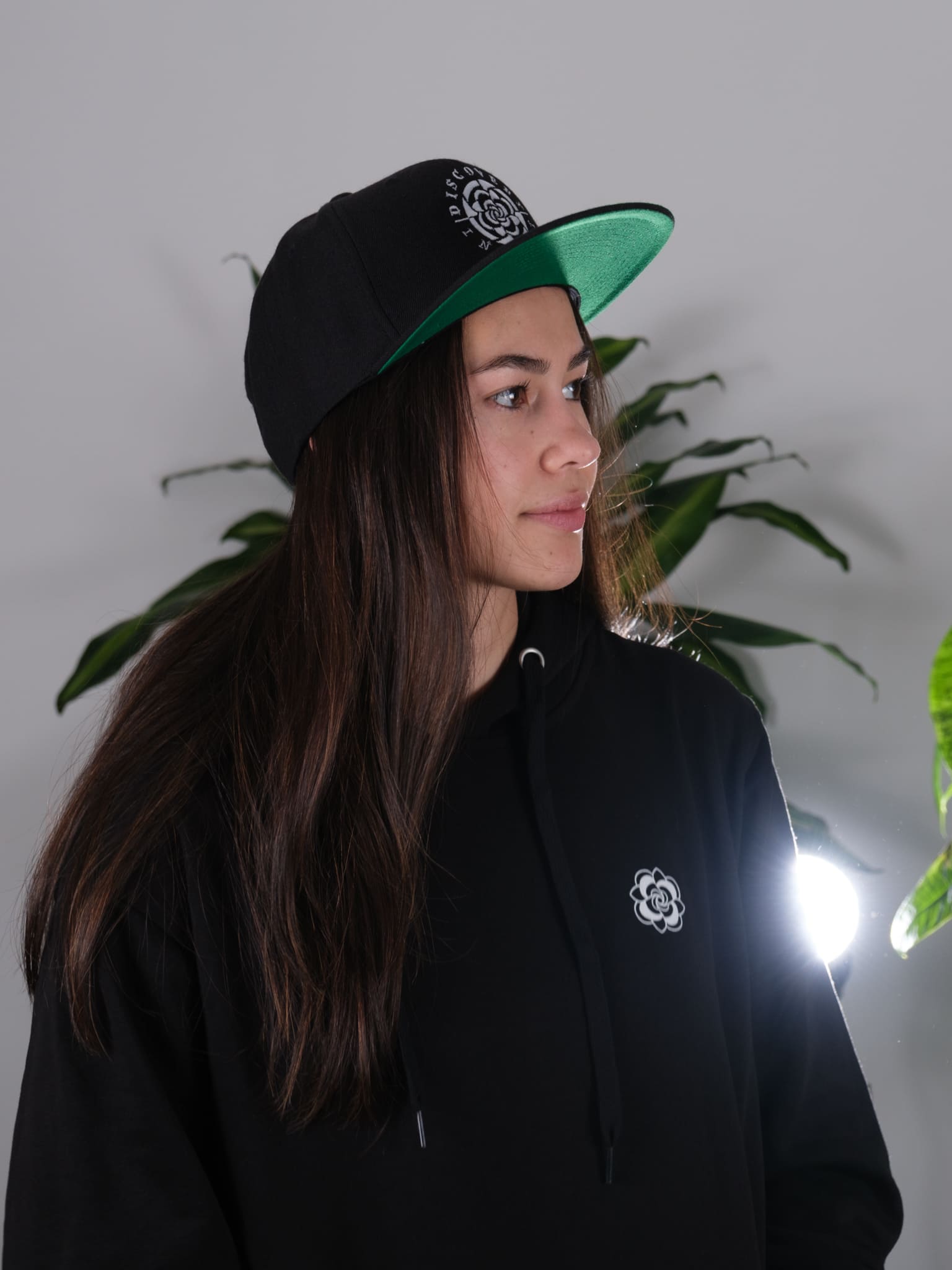 Side view of the Discovery Ink & Art Rising Snapback hat, showcasing the detailed artwork and stylish design.