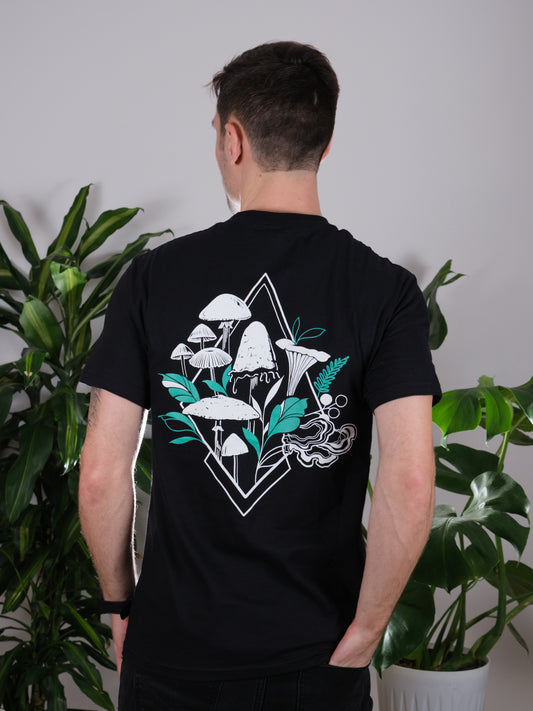 Back view of the Fragrance of Fall Tee on a male model, featuring tattoo-inspired geometric mushroom art.