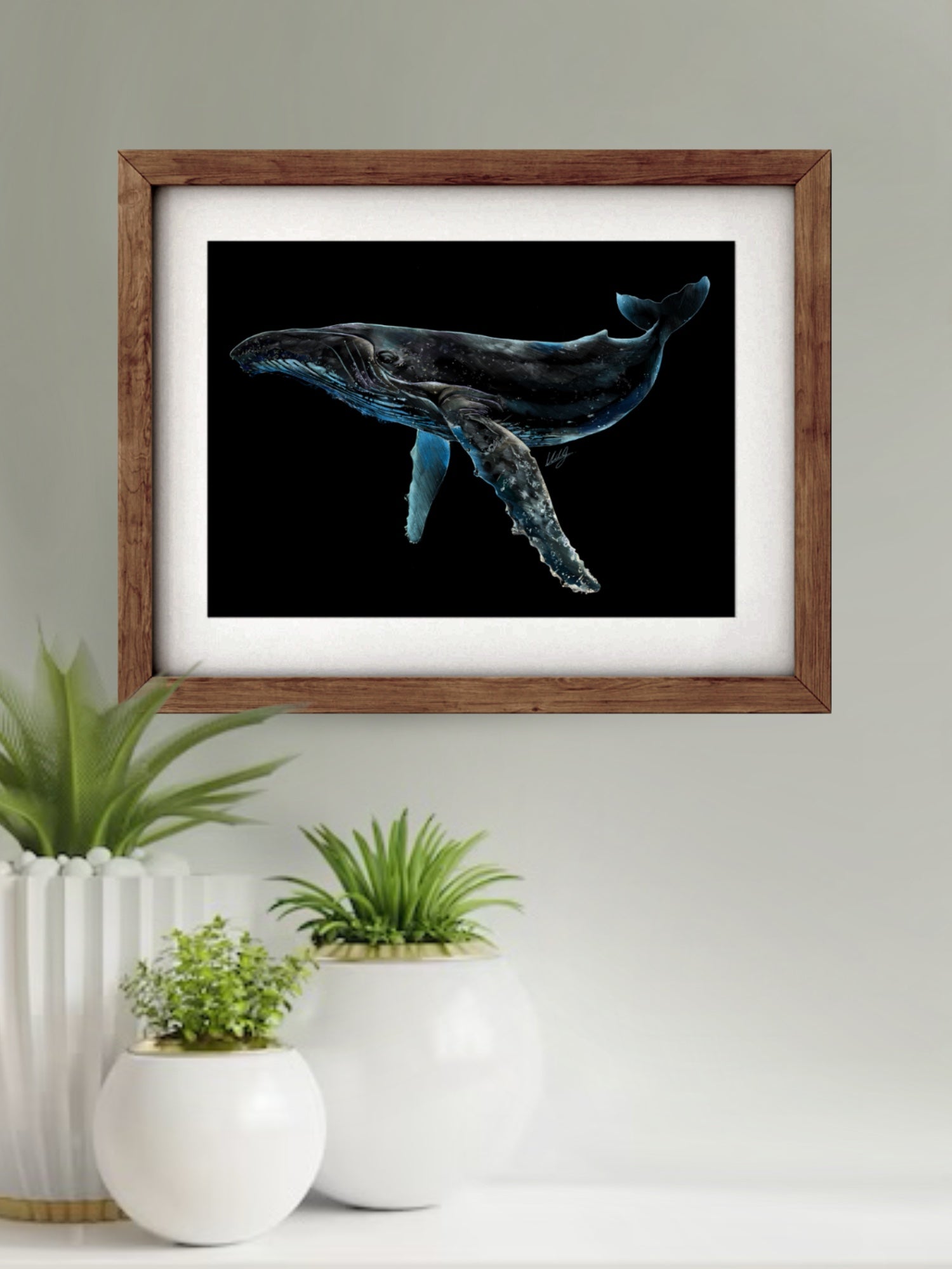 Framed Luminescent Humpback Whale Art Print displayed in a stylish living space, adding a touch of marine beauty and elegance to the decor.