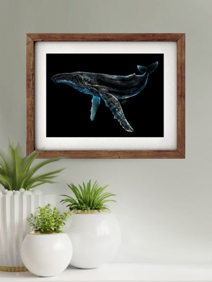 Framed Luminescent Humpback Whale Art Print displayed in a stylish living space, adding a touch of marine beauty and elegance to the decor.