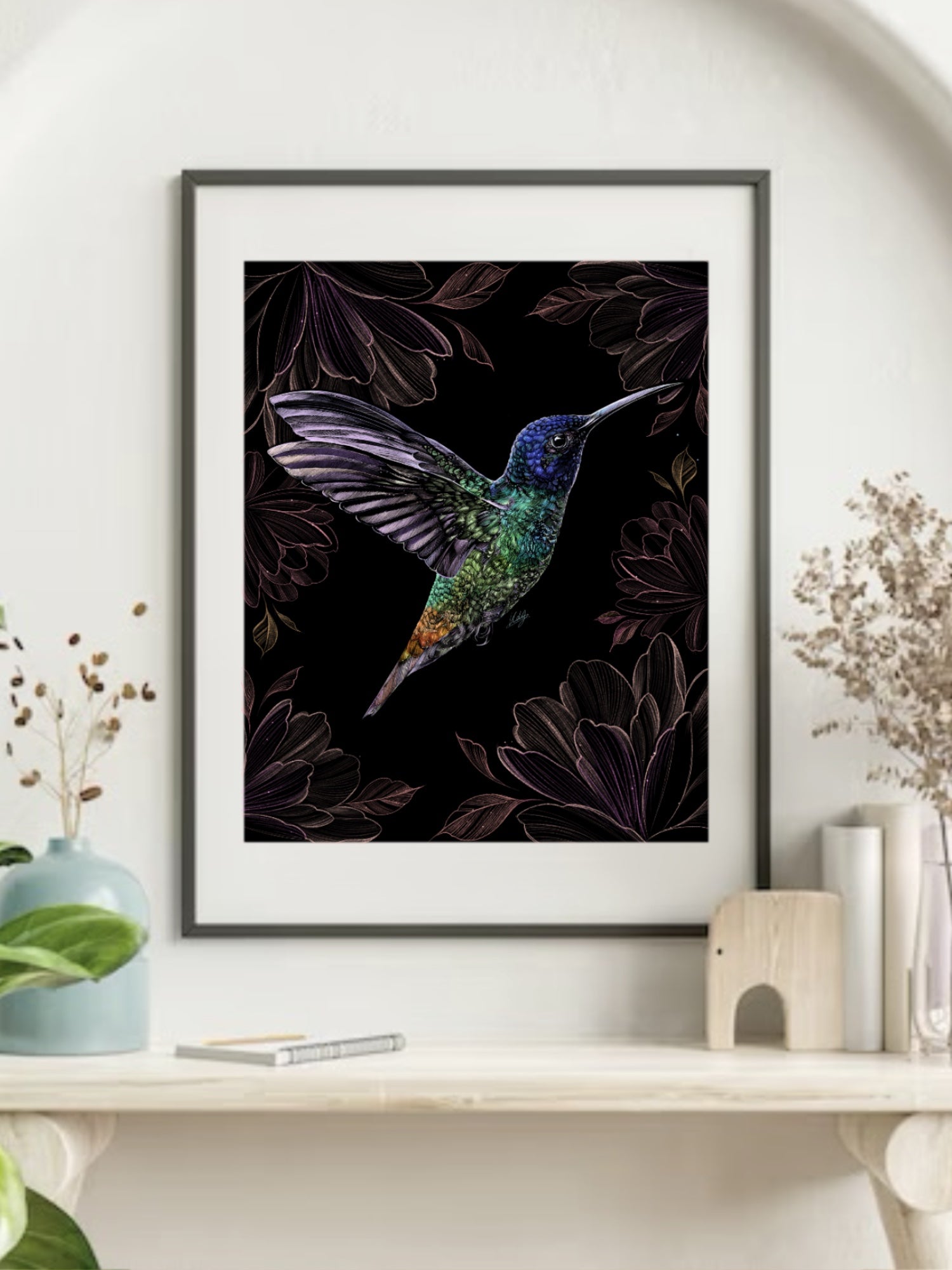 Framed Radiant Hummingbird Art Print displayed in a stylish living space, adding a touch of vibrant nature and floral elegance to the decor.